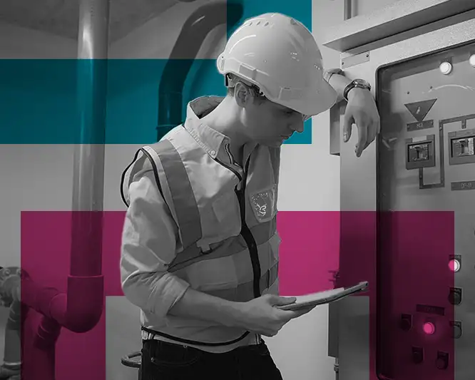 Man in hard hat looking at switchboard