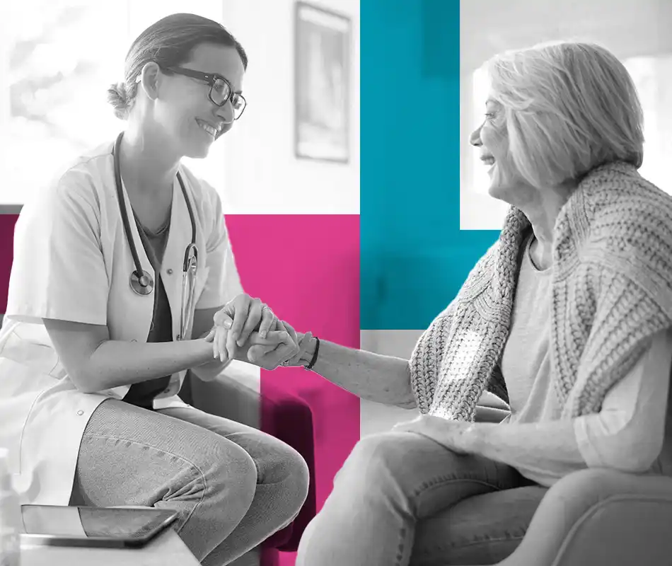 A doctor holding an older patient's hands